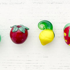 Fruit glass bead range including a raspberry glass bead, pear glass bead, tomato glass bead, lemon glass pendant, strawberry glass bead and a orange shaped glass bead