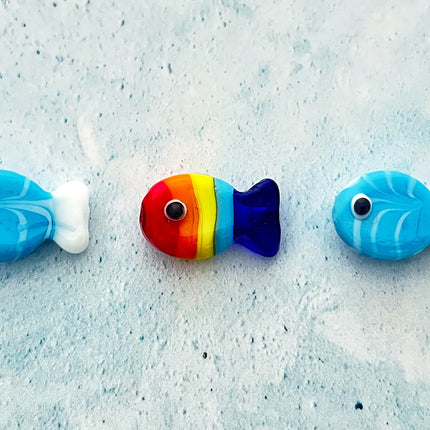 blue & white glass fish with rainbow coloured fish