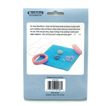 The back of a Beadalon Tacky Bead Mat package, showing the product description, an illustration of the blue mat with beads, and a barcode on a light blue background.