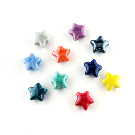 Ten small glossy star-shaped beads in assorted colors, including white, purple, blue, orange, dark blue, teal, red, and yellow, arranged on a plain white background.