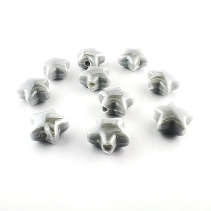 Ten small star-shaped ceramic beads with a glossy gray and white marbled pattern, arranged on a plain white background.