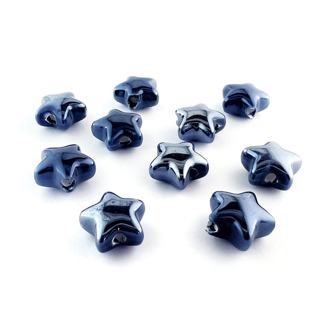 Ten glossy, dark blue ceramic star-shaped beads arranged on a plain white background.