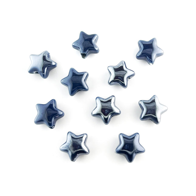Ten glossy, five-pointed star-shaped ceramic beads in a deep navy blue color, arranged on a plain white background.