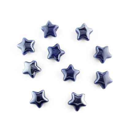 Ten glossy, five-pointed star-shaped ceramic beads in a deep navy blue color, arranged on a plain white background.