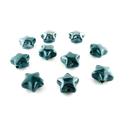 Ten glossy ceramic star-shaped beads in a deep teal blue-green color, arranged on a plain white background.