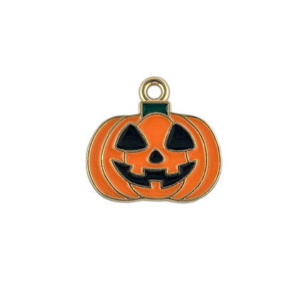 An orange pumpkin-shaped enamel charm with a carved jack-o'-lantern face and a gold-tone metal border and top loop, shown on a plain white background.