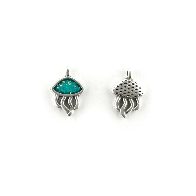 A pair of metal jellyfish charms, one showing a vibrant turquoise blue inlay with tiny gold flecks, and the other showing a textured, perforated silver top, set against a plain white background.