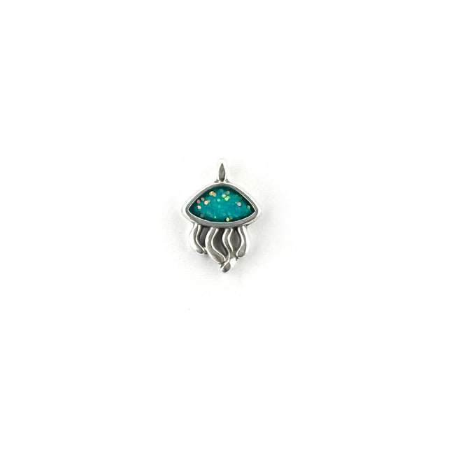 A small silver pendant shaped like a jellyfish, featuring a turquoise blue top with tiny gold star-like specks and flowing silver tentacles, shown on a plain white background.