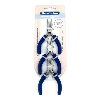 Beadalon Mini Tool Kit containing three pairs of jewelry pliers with blue handles and silver metal jaws, packaged on a cardboard backing.