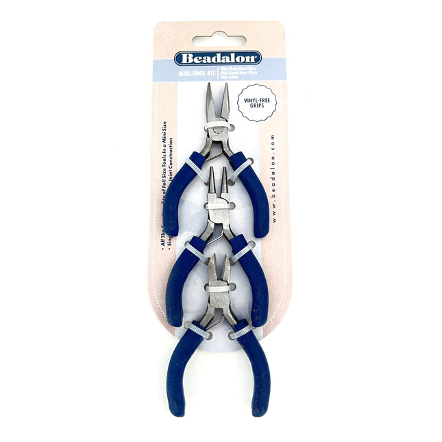 Beadalon Mini Tool Kit containing three pairs of jewelry pliers with blue handles and silver metal jaws, packaged on a cardboard backing.