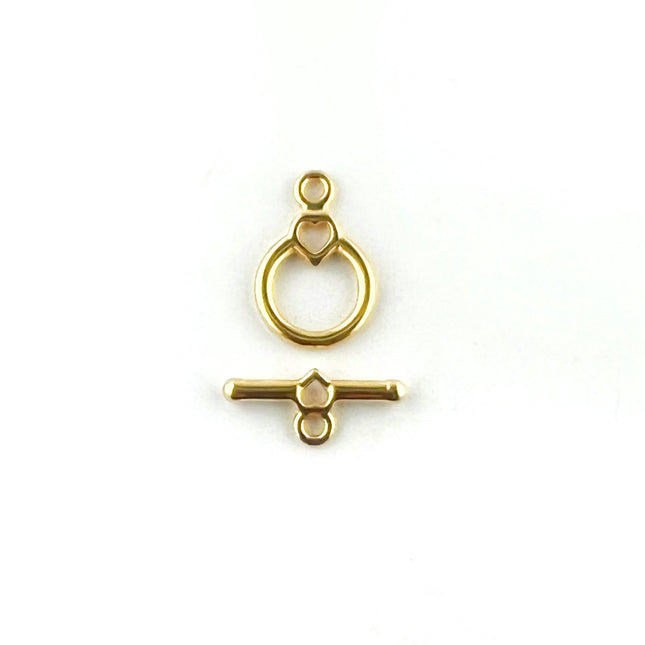 Gold-toned metal toggle clasp with a ring loop and horizontal bar, shown on a plain white background.